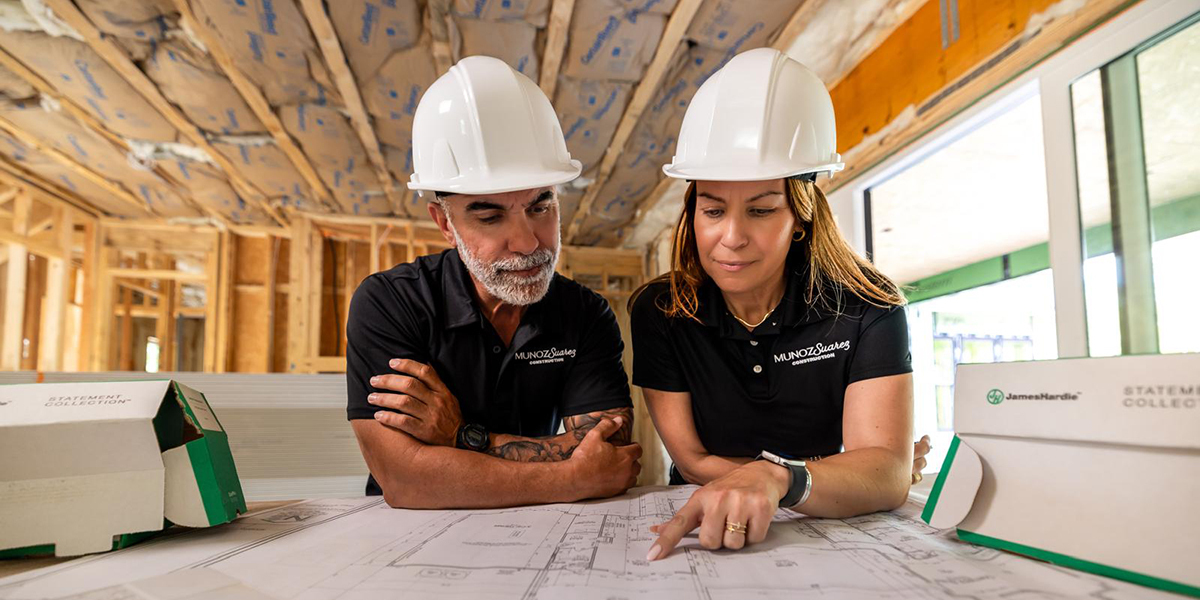 Tony Munoz and another member of Martin Home Exteriors looking at a house plan